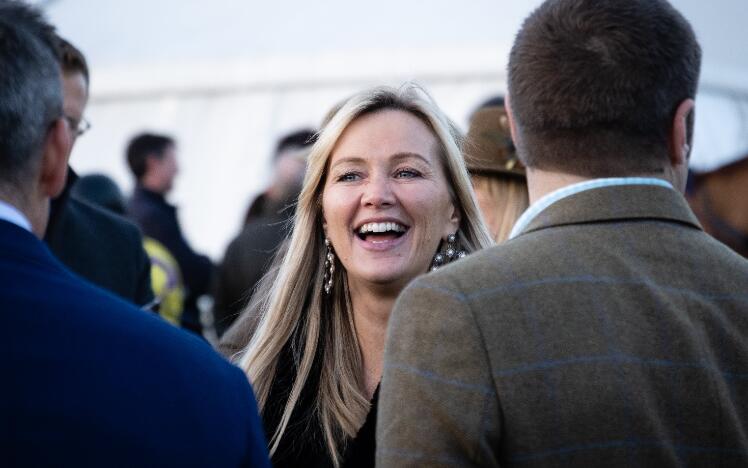 A race goer at Hereford Races enjoying a chat with friends